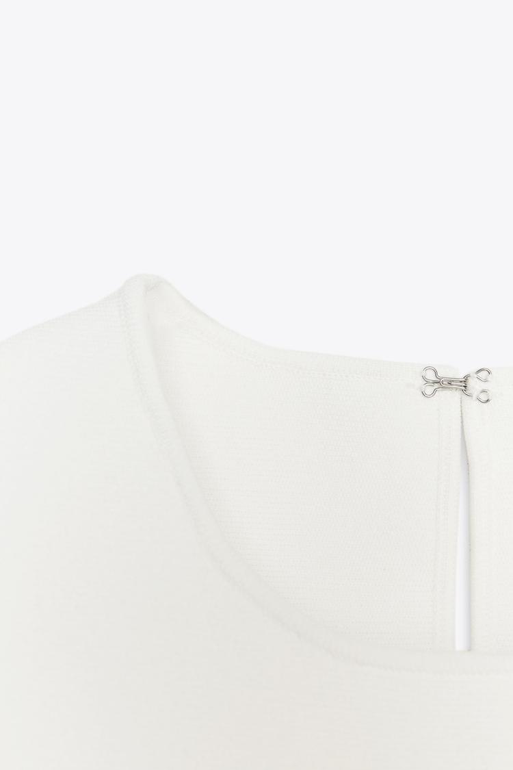 TOP EN MAILLE PÉPLUM AVEC LACETS